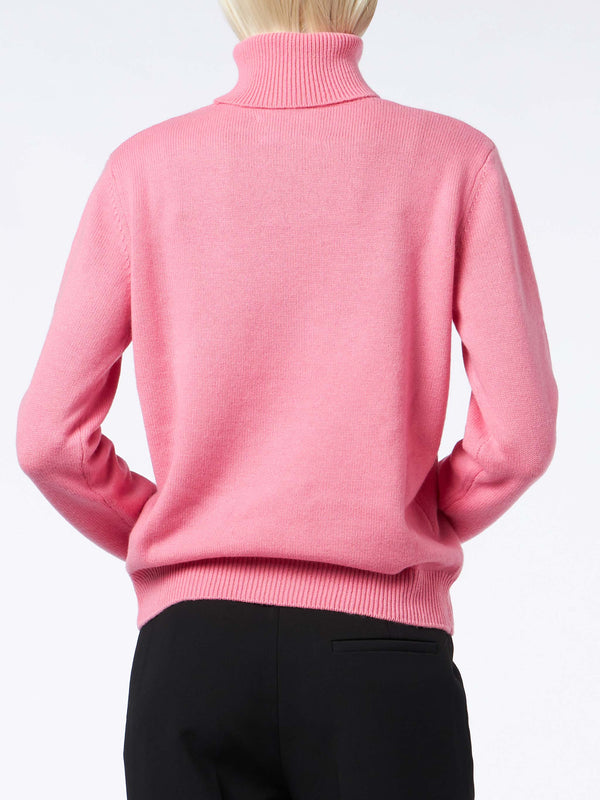 Woman knitted pink turtleneck sweater