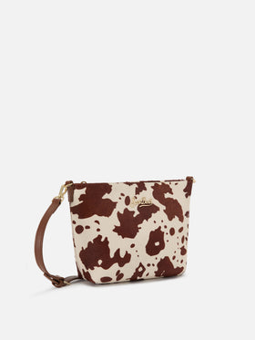 Aline Tasche aus Ponyfell mit Kuhmuster und Metall-Logoplakette 