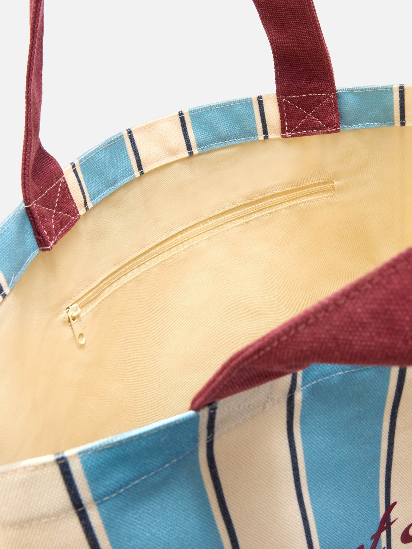 Essential canvas tote bag with light blue and white stripes and contrasting logo