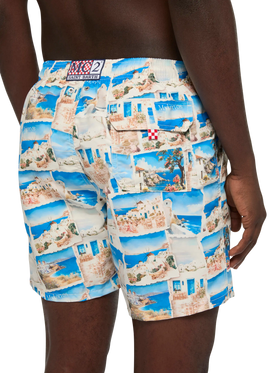 Mid-length Gustavia swim-shorts with Mykonos postcard print | AI CO-CREATED DESIGN BY RICKDICK - POWERED BY RED-EYE