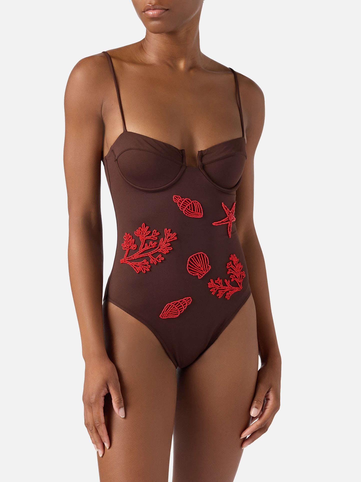 Medea one-piece swimsuit in brown with beaded sea-themed decorations